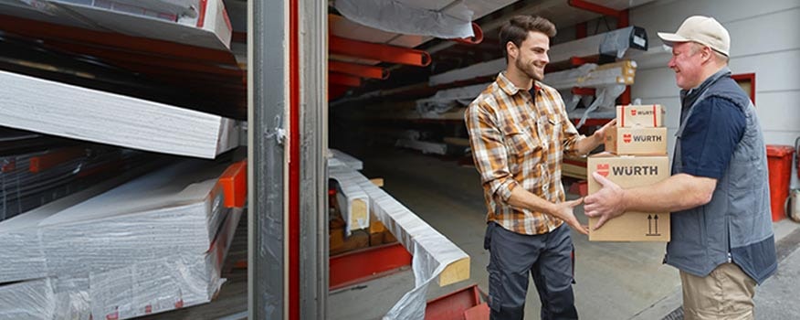Delivery driver handing Würth products to a shop owner