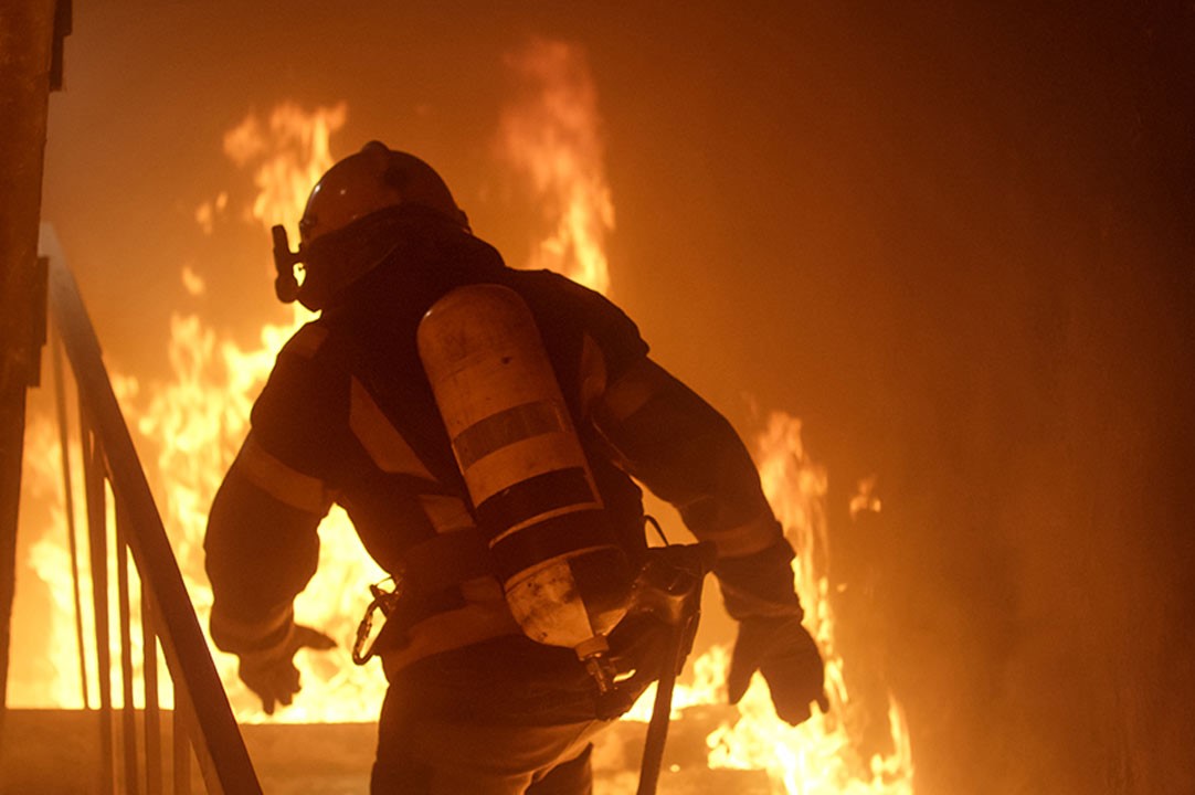 Picture of a first responder in a burning building