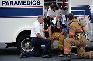 Image of first responders helping a fellow first responder who needs help
