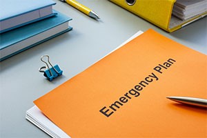 PIcture of desk with an emergency plan placed on top.