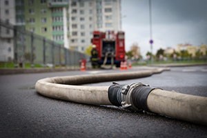 Image of hoses on the ground at a scene of a fire